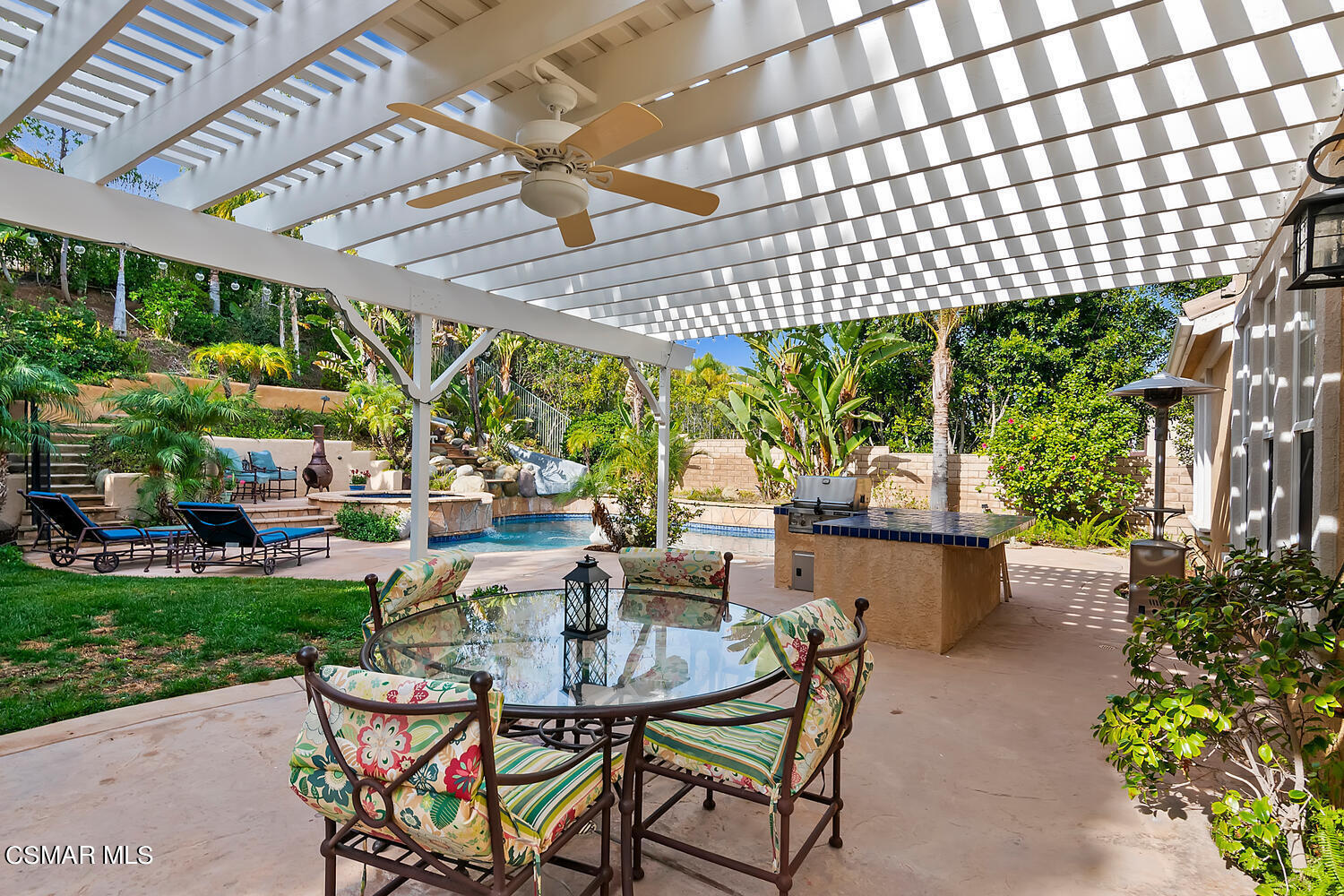 569 Rustic Hills Drive Simi Valley, CA 93065 - Photo 47 of 59 a view of patio with table and chairs potted plants and palm trees