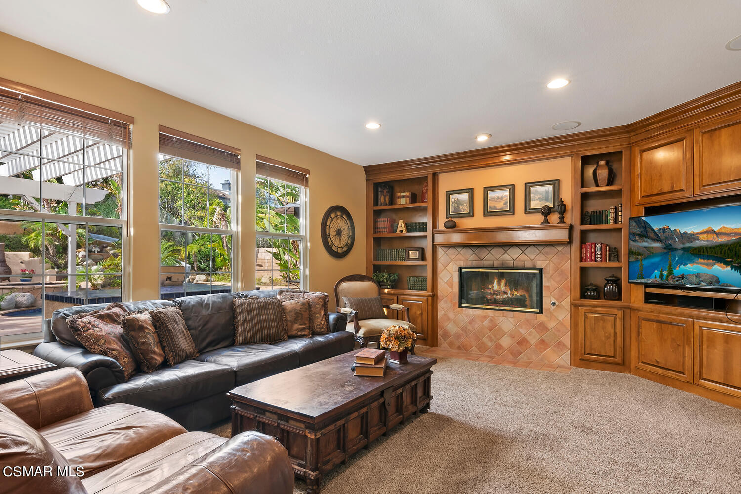 569 Rustic Hills Drive Simi Valley, CA 93065 - Photo 10 of 59 a living room with furniture large window and a fireplace