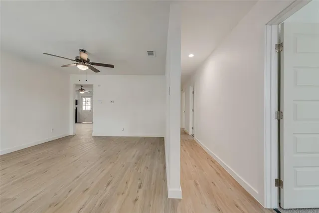a view of an empty room and wooden floor