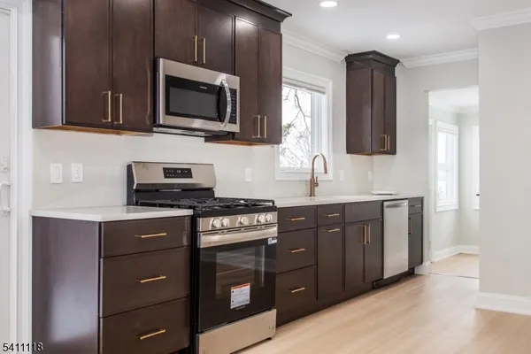 a kitchen with stainless steel appliances granite countertop a stove a microwave and sink