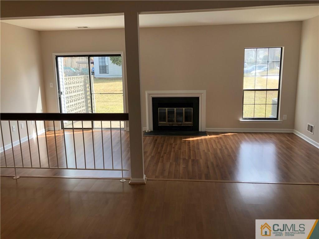 1804 Timber Oaks Road Edison, NJ 08820 - Photo 13 of 23 an empty room with wooden floor and windows