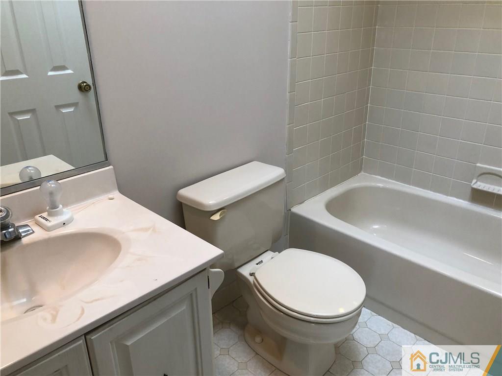 1804 Timber Oaks Road Edison, NJ 08820 - Photo 14 of 23 a white toilet sitting next to a bathroom sink