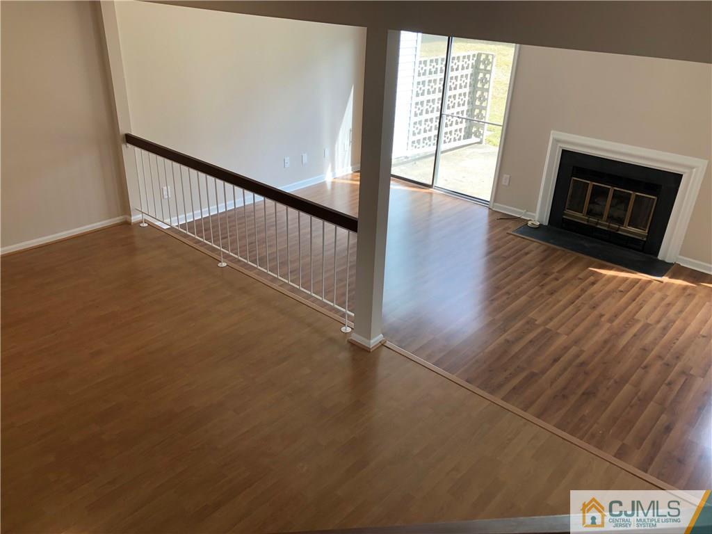 1804 Timber Oaks Road Edison, NJ 08820 - Photo 16 of 23 a view of an empty room with wooden floor and a window