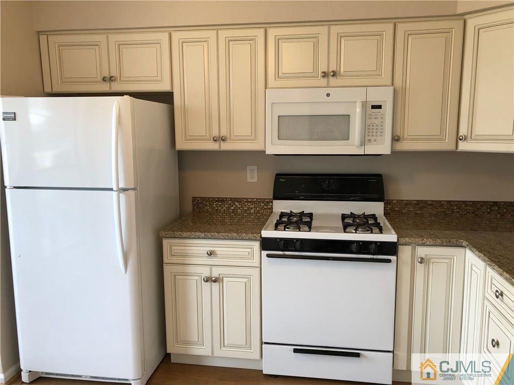 1804 Timber Oaks Road Edison, NJ 08820 - Photo 3 of 23 a kitchen with white cabinets and white appliances