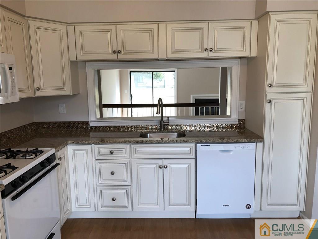 1804 Timber Oaks Road Edison, NJ 08820 - Photo 4 of 23 a kitchen with granite countertop a sink cabinets and stainless steel appliances