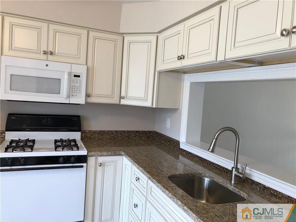 1804 Timber Oaks Road Edison, NJ 08820 - Photo 5 of 23 a kitchen with granite countertop white cabinets and sink