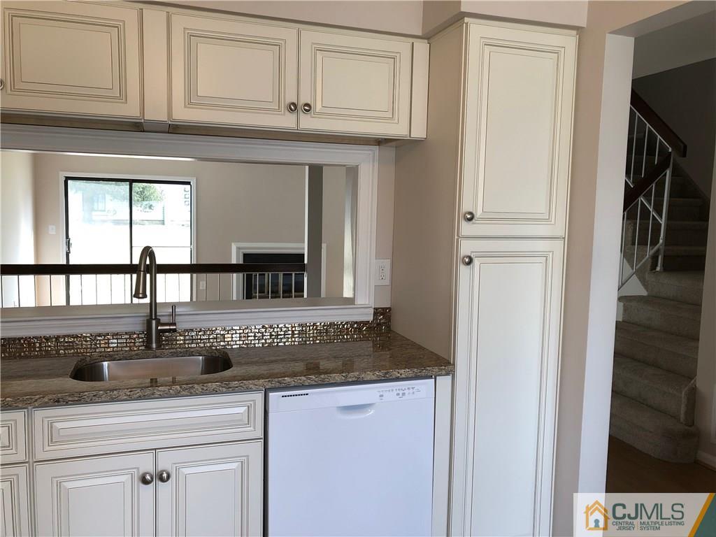 1804 Timber Oaks Road Edison, NJ 08820 - Photo 8 of 23 a kitchen with stainless steel appliances granite countertop a sink and cabinets