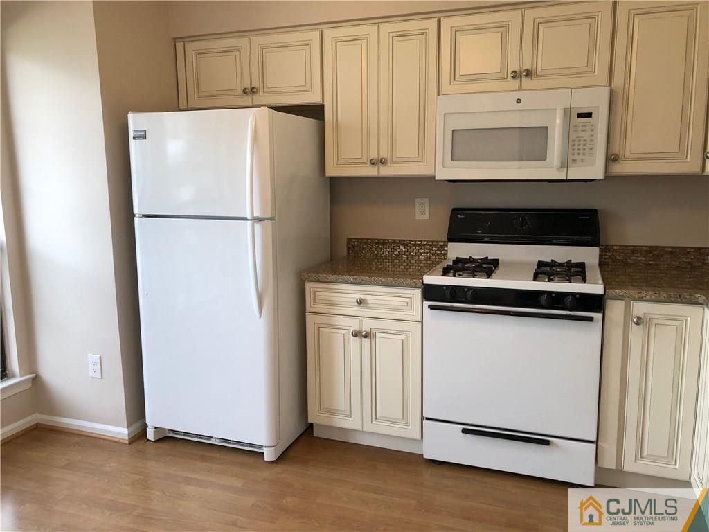 1804 Timber Oaks Road Edison, NJ 08820 - Photo 9 of 23 a white refrigerator freezer and a stove sitting inside of a kitchen