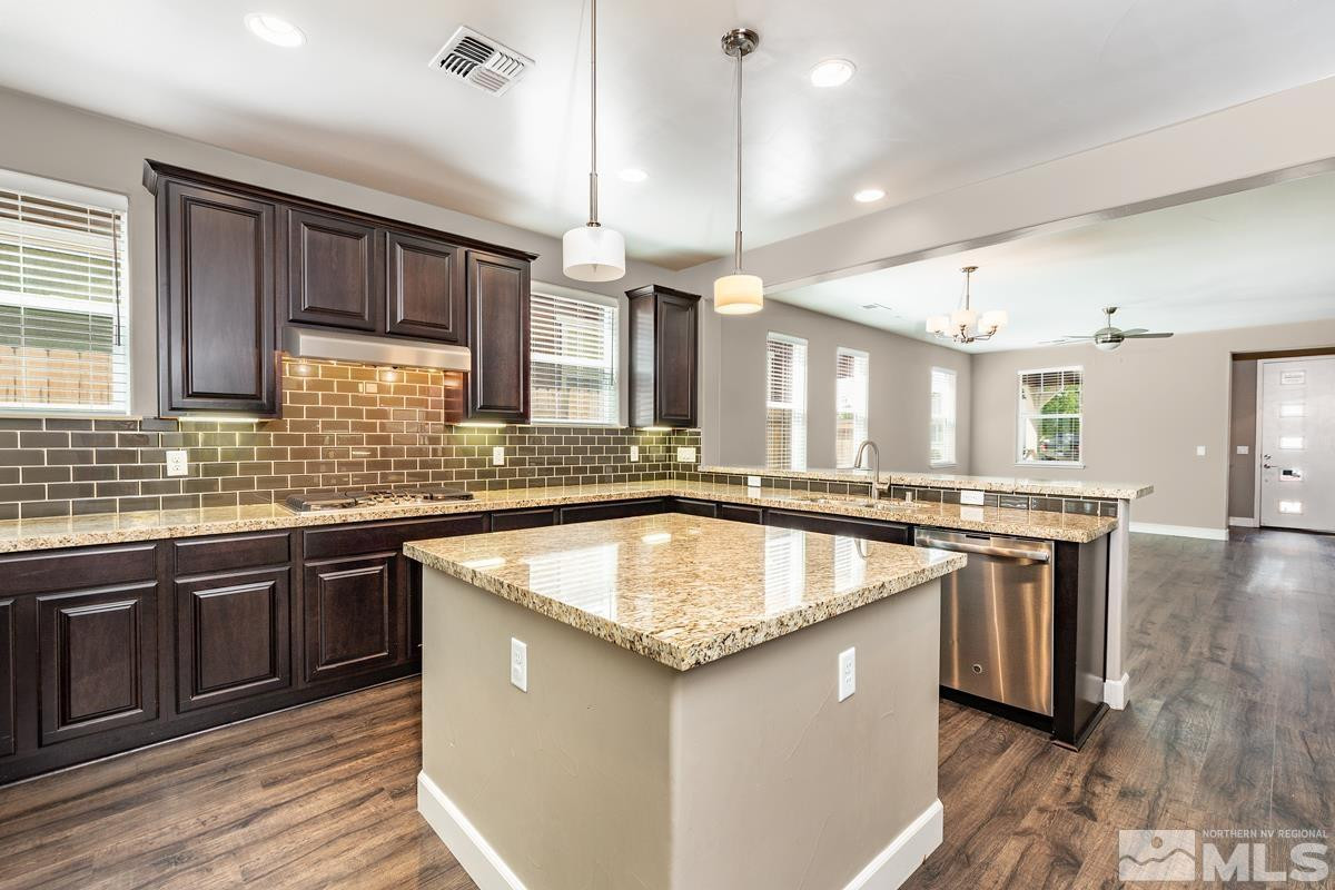 310 Mt Rose Street Reno, NV 89509 - Photo 8 of 18 a kitchen with stainless steel appliances granite countertop a sink a stove and a wooden floors