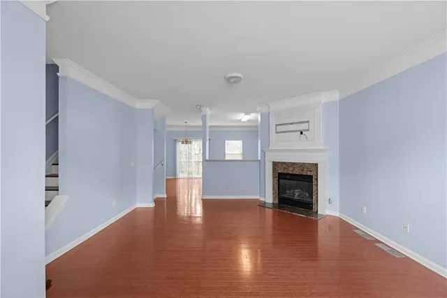 a view of an empty room with window and fire place
