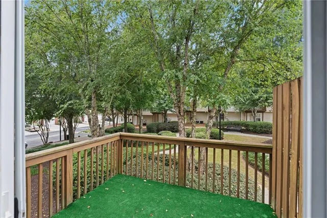 a view of a wooden deck next to a yard