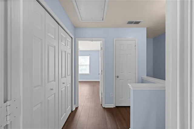 a view of a hallway with wooden floor