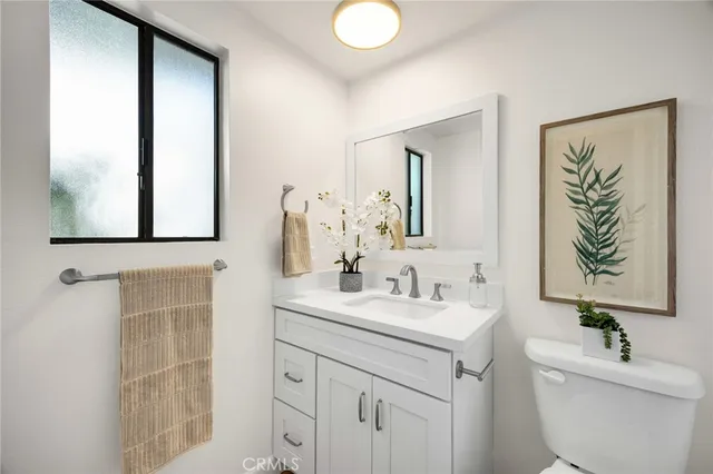 a bathroom with a sink toilet and mirror