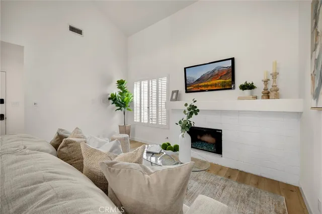 a living room with furniture fireplace and potted plant