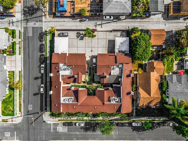 an aerial view of multiple houses with yard
