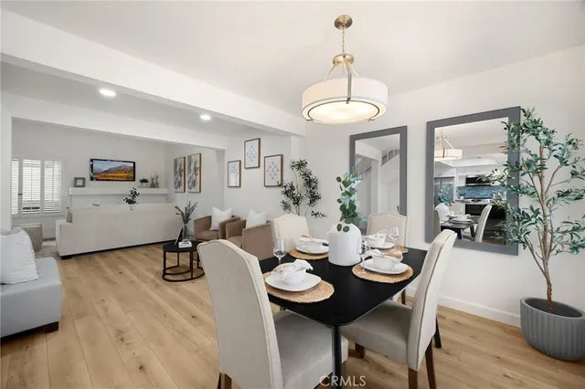 a view of a dining room with furniture wooden floor and chandelier