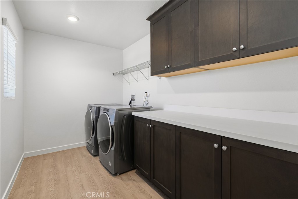 34727 Ribbon Grass Way Murrieta, CA 92563 - Photo 21 of 54 Upstairs laundry with ample cabinets, folding space & natural light