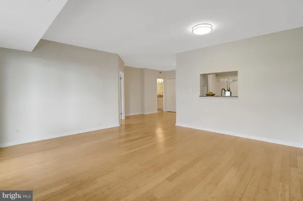 a view of a room with wooden floor and a window