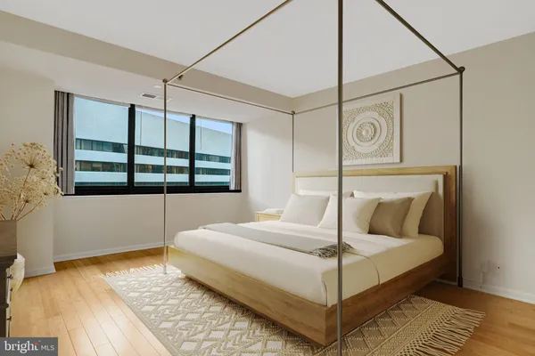 a bedroom with a bed and window