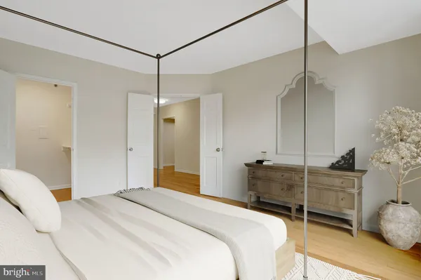 a bedroom with a bed dresser and a window