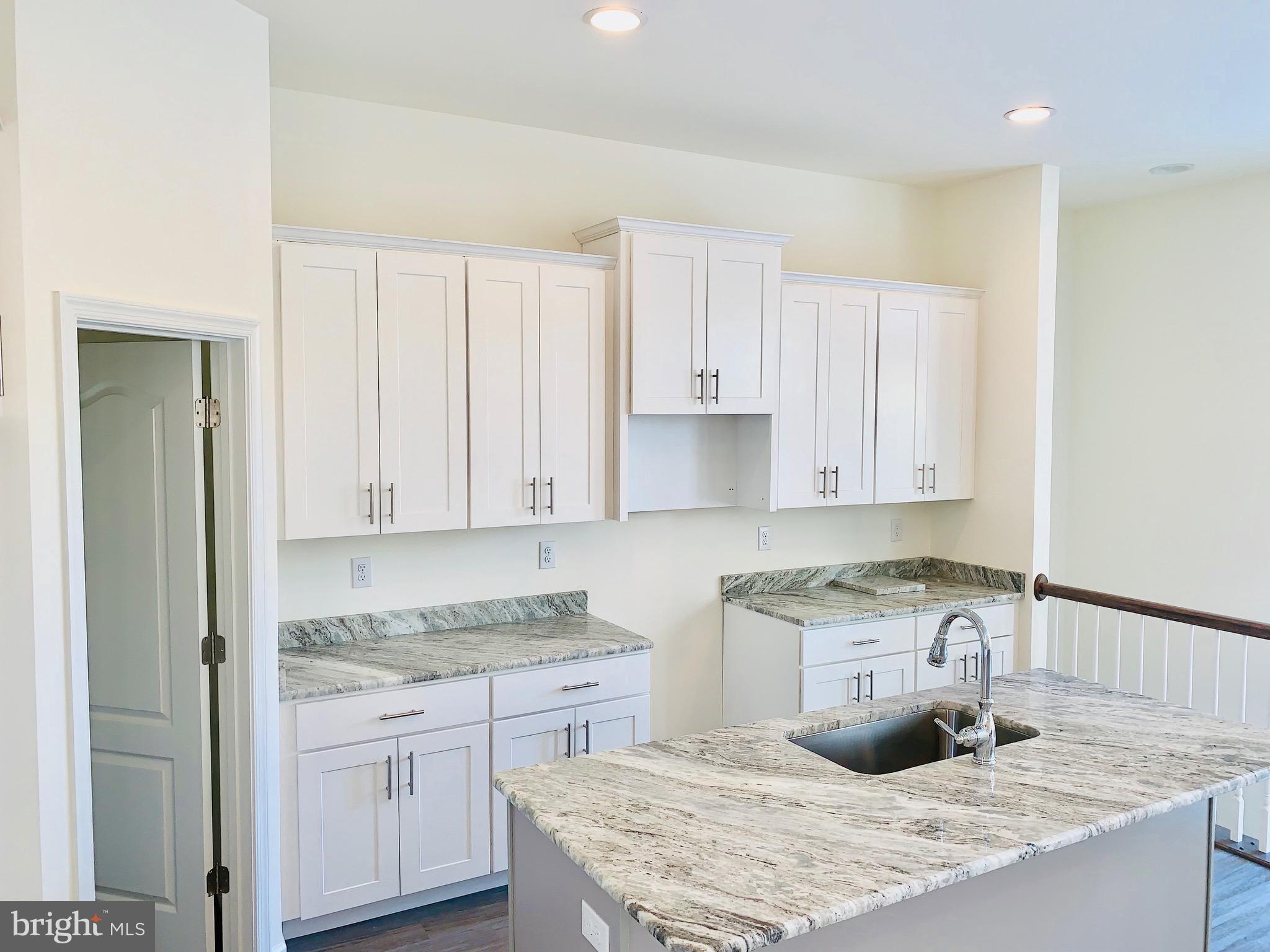 6 Patriots Way Georgetown, DE 19947 - Photo 26 of 35 a kitchen with granite countertop a sink a stove and cabinets