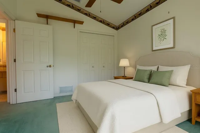 a bedroom with a bed and a painting on the wall