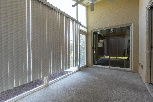 a view of a house with glass door and brick wall