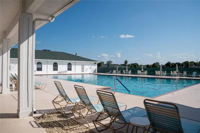 a view of a balcony with two chairs and a table