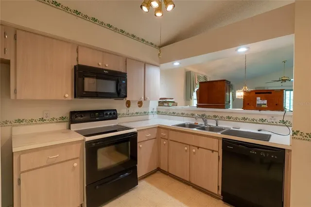 a kitchen with a sink stove and microwave