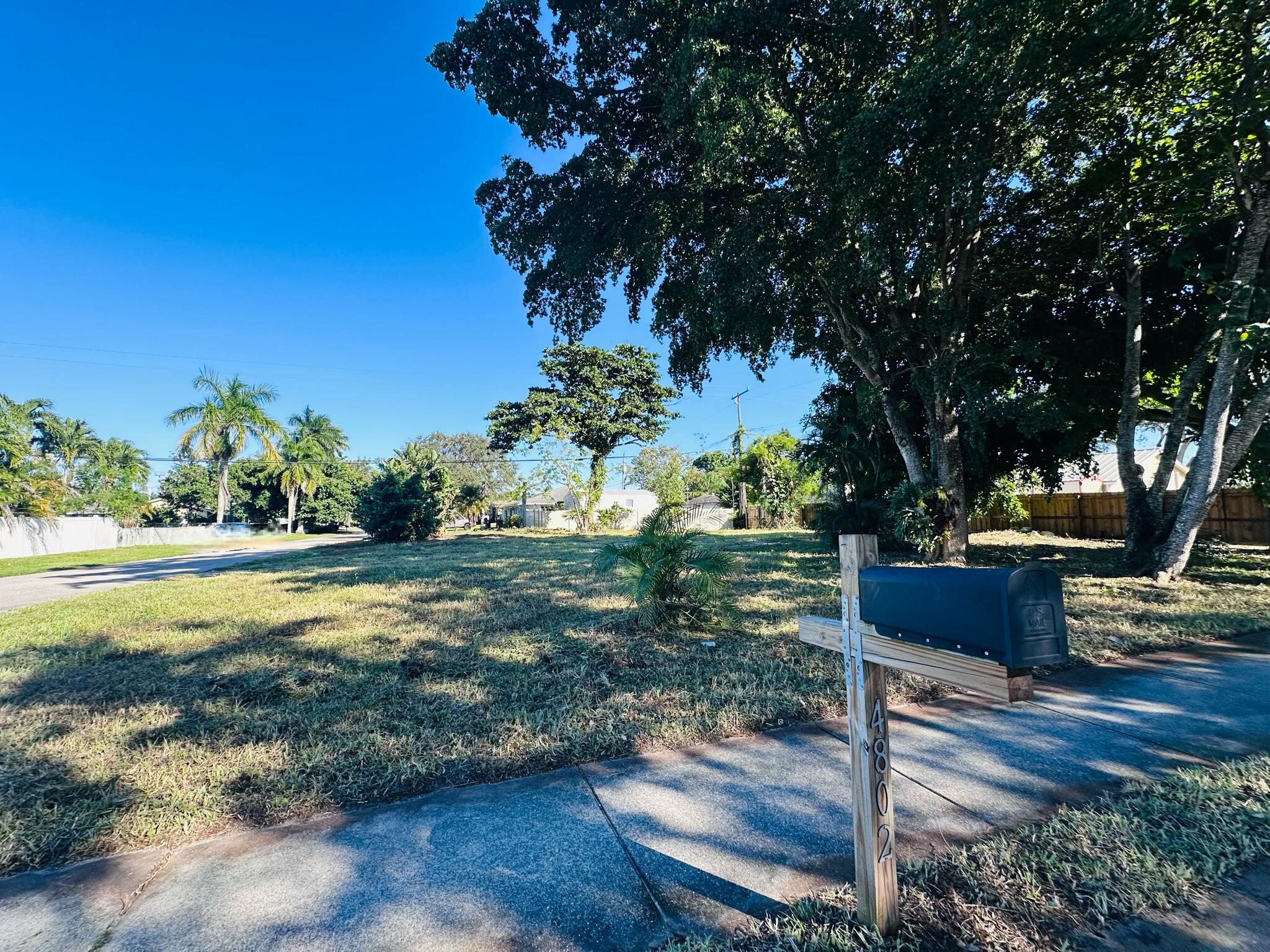4802 Bonanza Road Lake Worth, FL 33467 - Photo 9 of 10 a wooden bench sitting in the middle of a yard