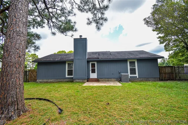 a house view with a sitting space and garden