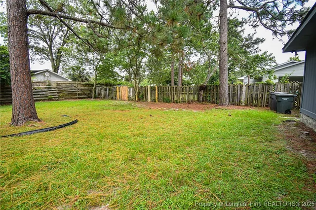 a swimming pool with trees in front of it