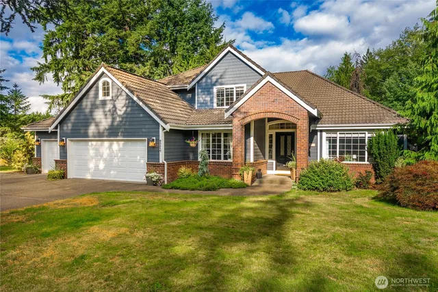 a front view of a house with a yard and garage