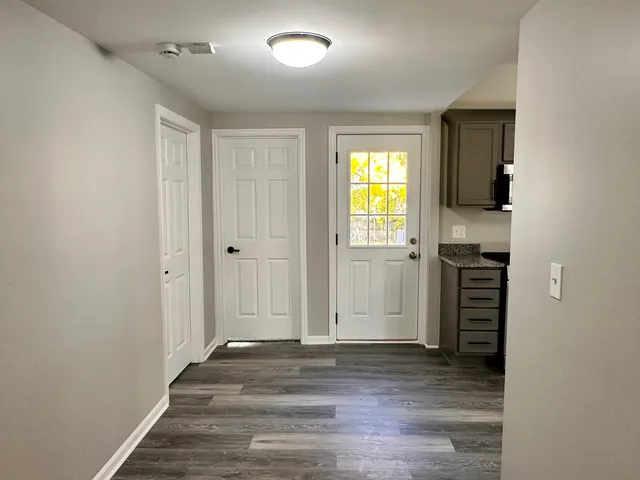wooden floor in an empty room with a window