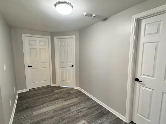 an empty room with wooden floor and closet