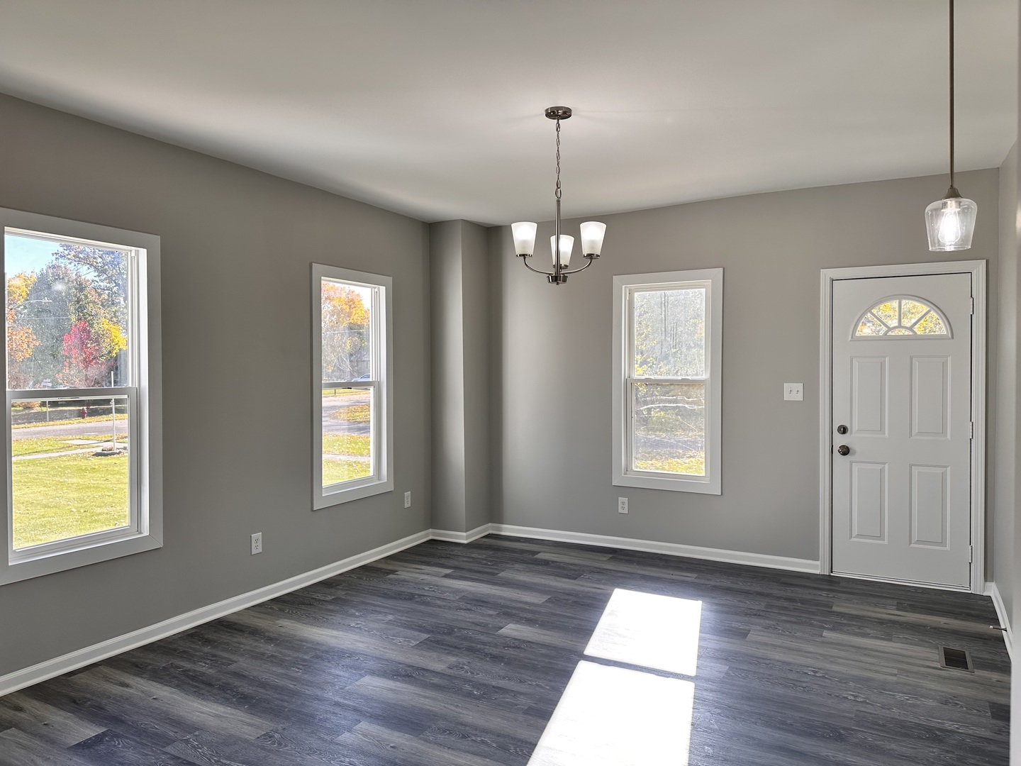 210 West Hall Street Leland, IL 60531 - Photo 9 of 36 an empty room with wooden floor and windows