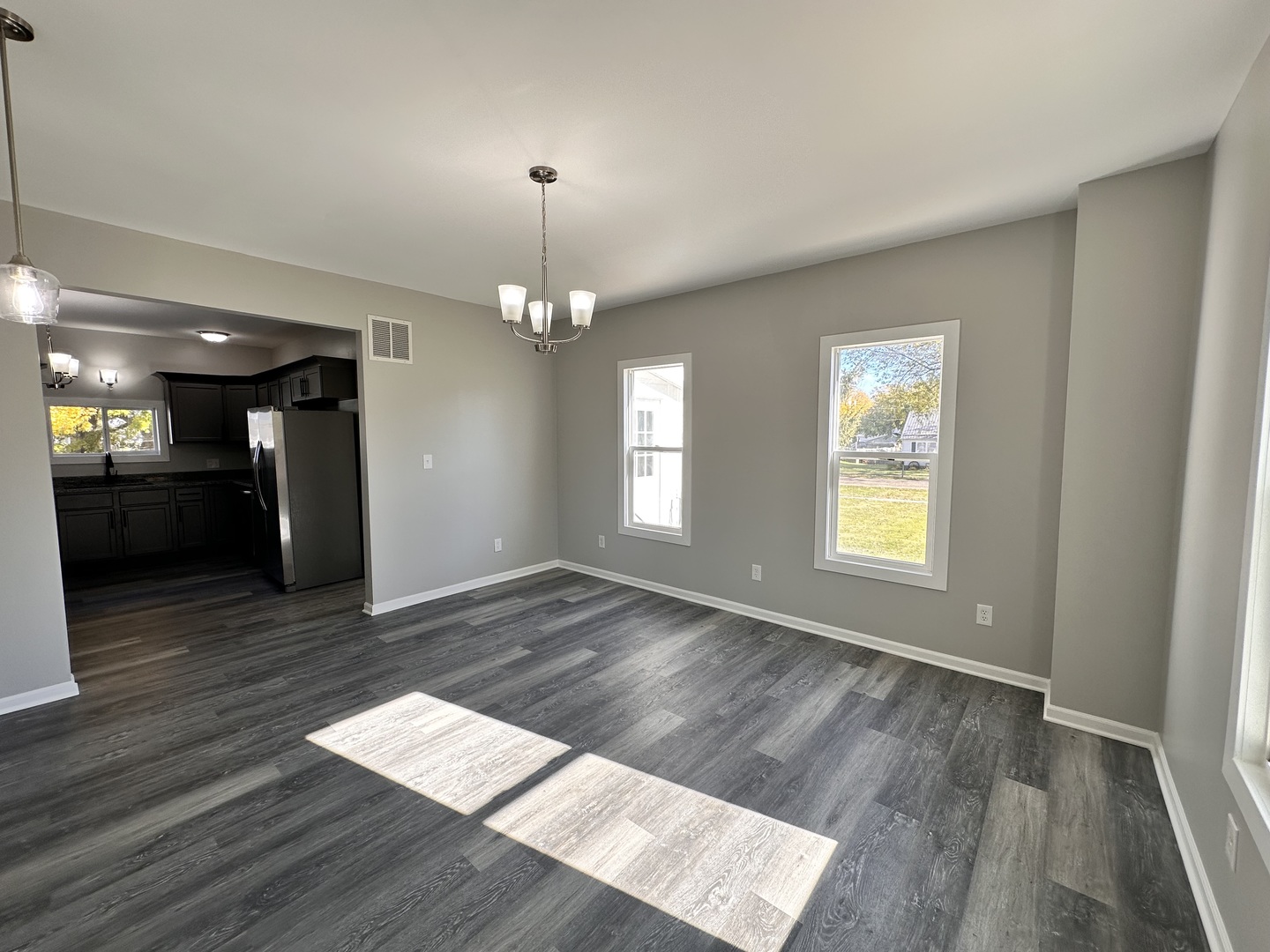210 West Hall Street Leland, IL 60531 - Photo 10 of 36 an empty room with wooden floor and windows