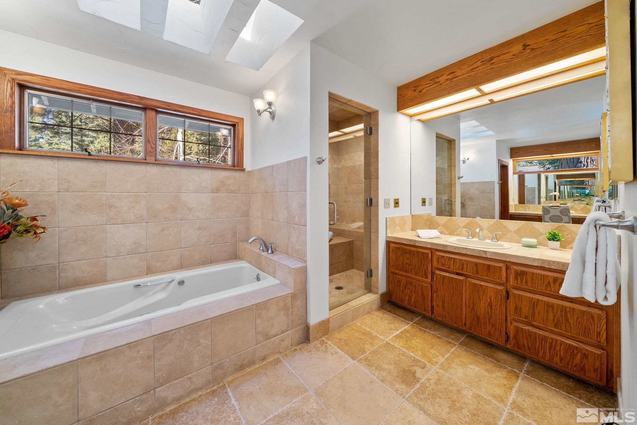 106 Jobs Peak Road Incline Village, NV 89451 - Photo 19 of 40 a spacious bathroom with a tub sink and mirror