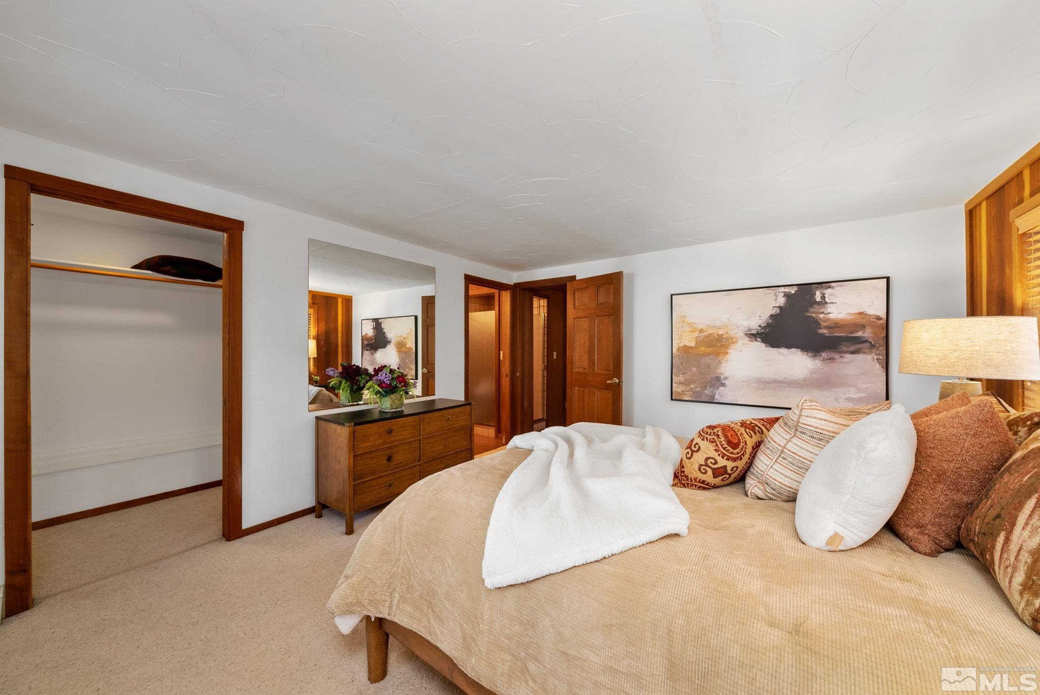 106 Jobs Peak Road Incline Village, NV 89451 - Photo 23 of 40 a large bedroom with a bed and dresser with mirror