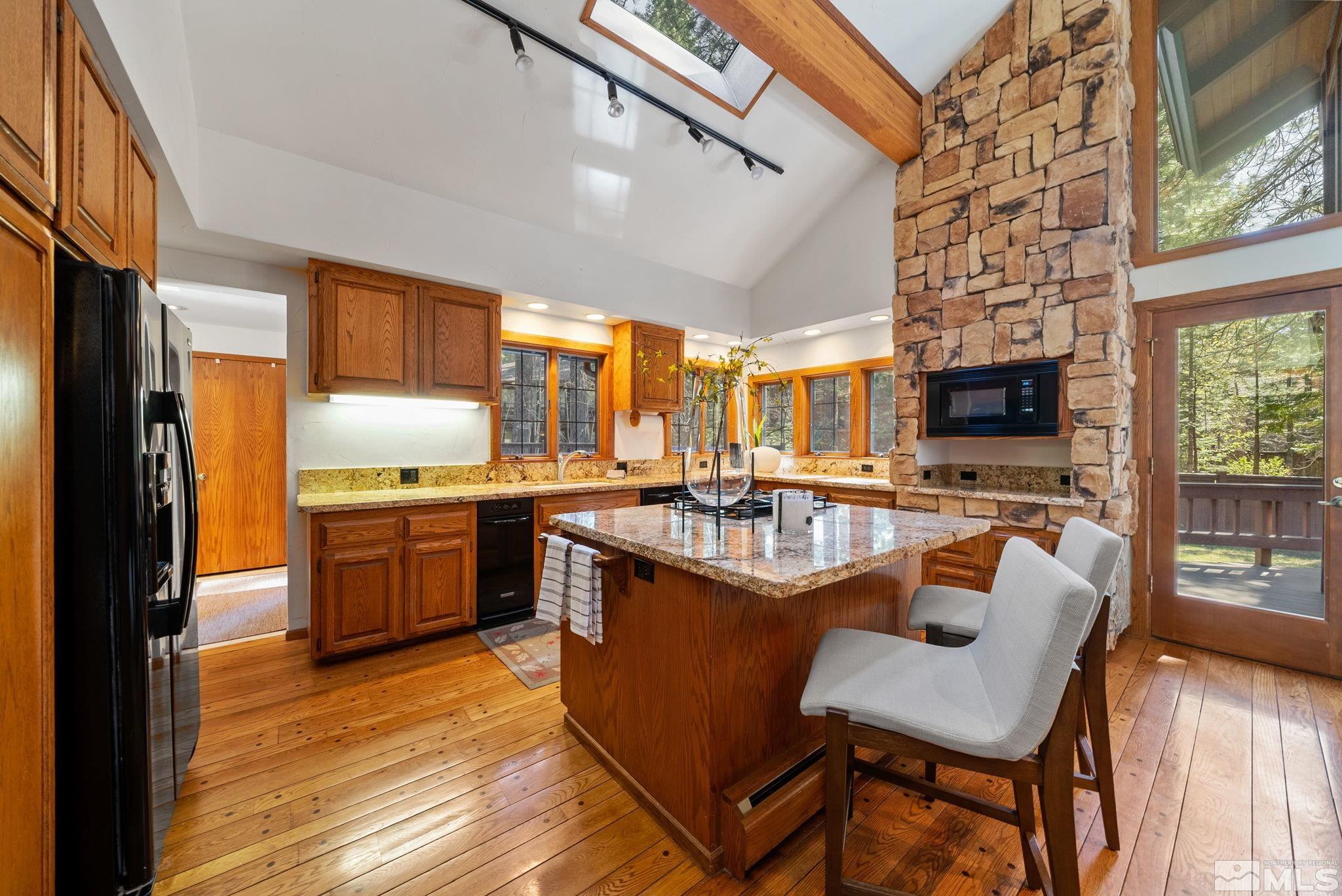 106 Jobs Peak Road Incline Village, NV 89451 - Photo 6 of 40 a kitchen with stainless steel appliances granite countertop sink stove top oven and cabinets