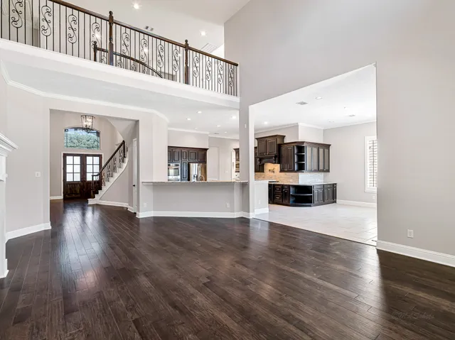 a view of a kitchen with furniture and wooden floor