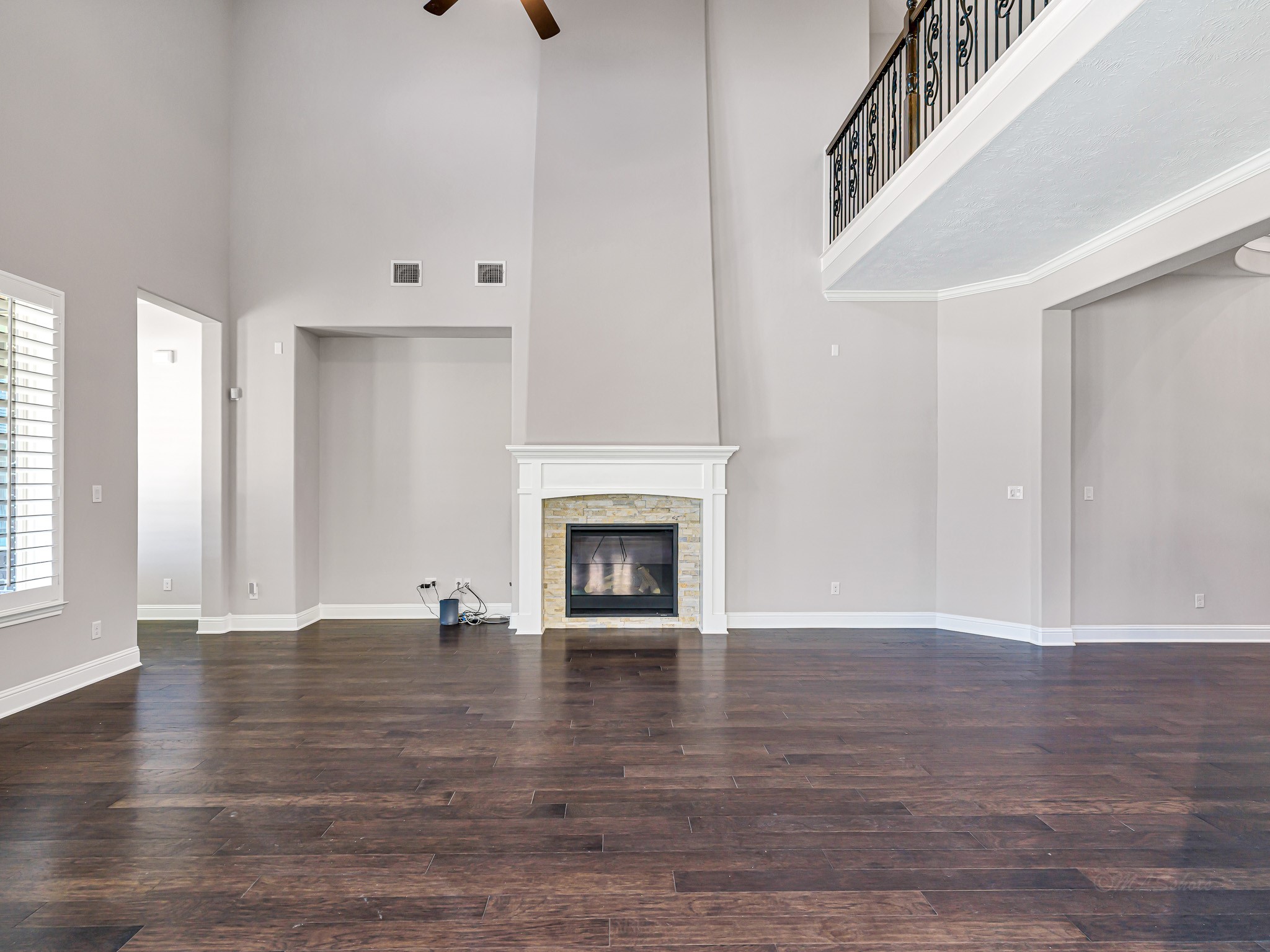 1710 Rice Mill Drive Katy, TX 77493 - Photo 12 of 50 a view of an empty room with wooden floor fireplace and a window