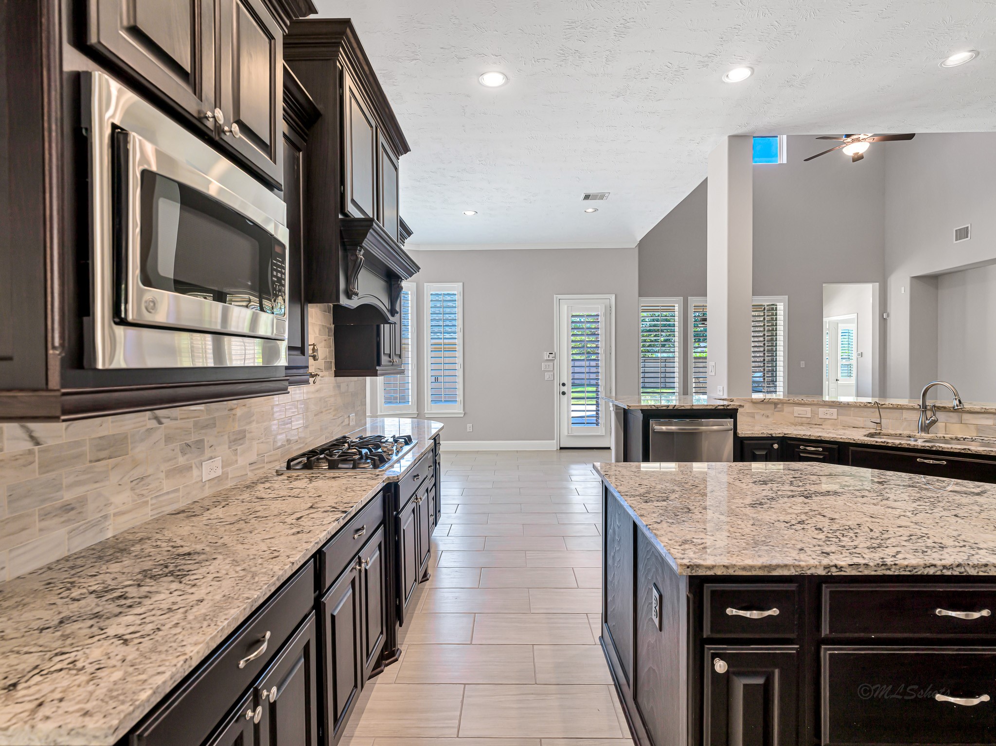 1710 Rice Mill Drive Katy, TX 77493 - Photo 17 of 50 a kitchen with granite countertop kitchen island stainless steel appliances a sink stove and cabinets