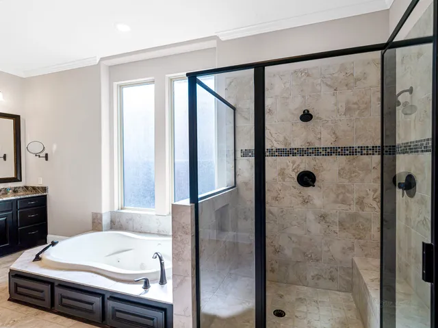a bathroom with a granite countertop sink a shower and a mirror