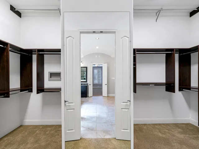 a view of a hallway with wooden shelves