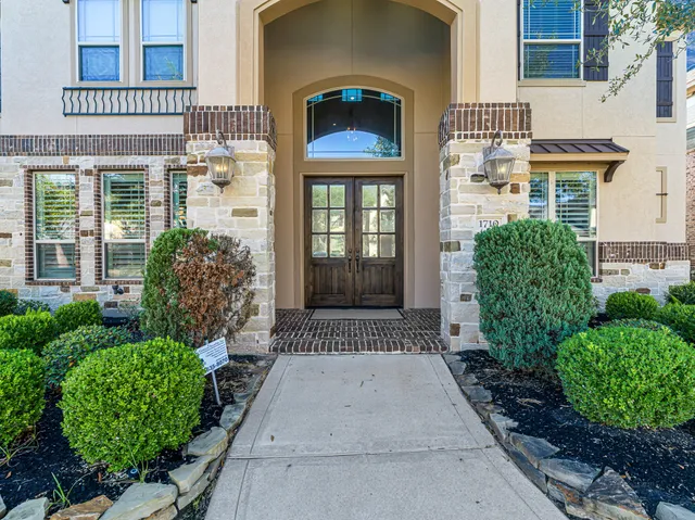 front view of a brick house with a large windows