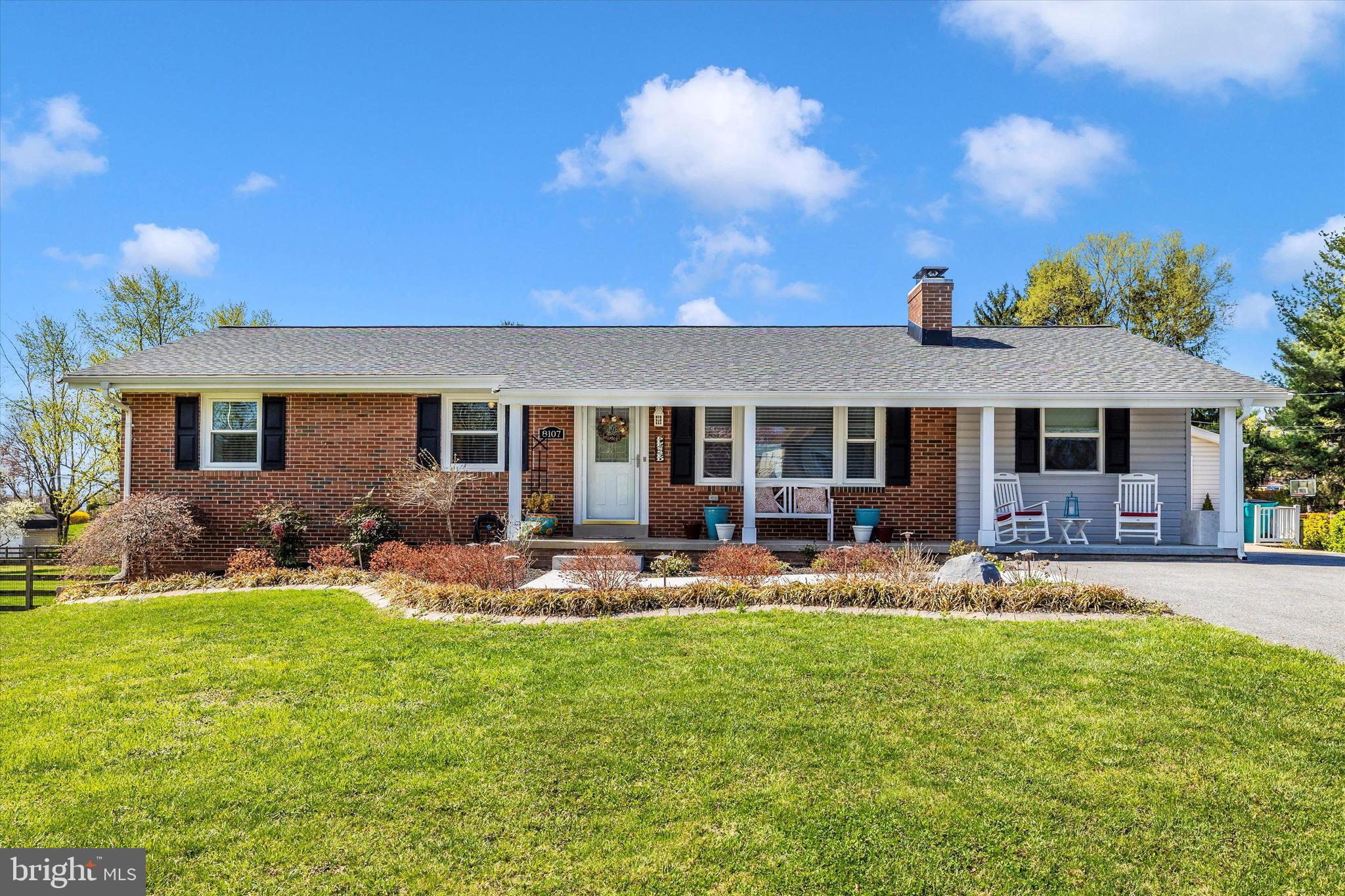 a front view of house with a garden and patio