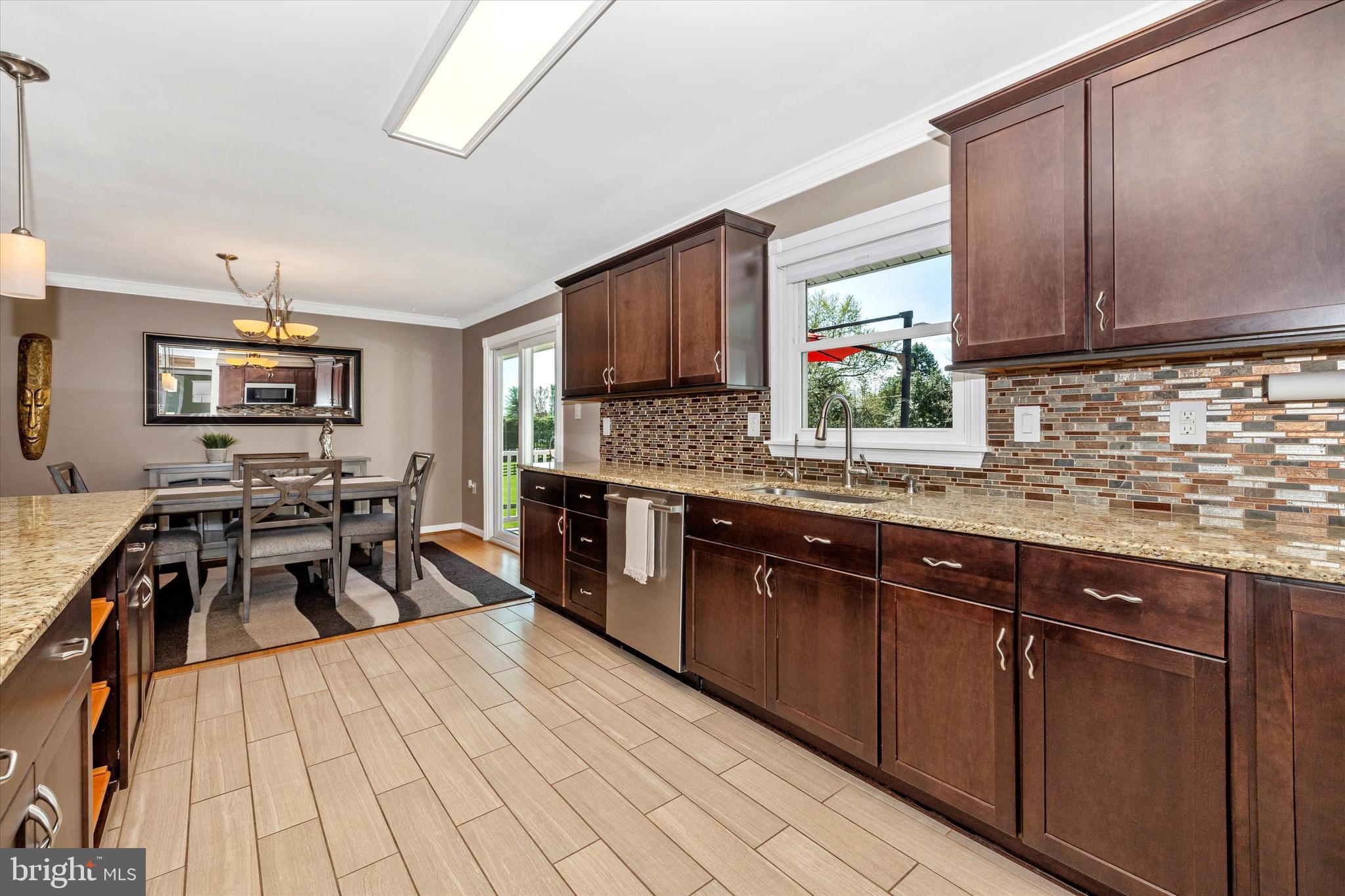 8107 Broadview Drive Frederick, MD 21701 - Photo 13 of 54 a kitchen with granite countertop a sink stove and cabinets