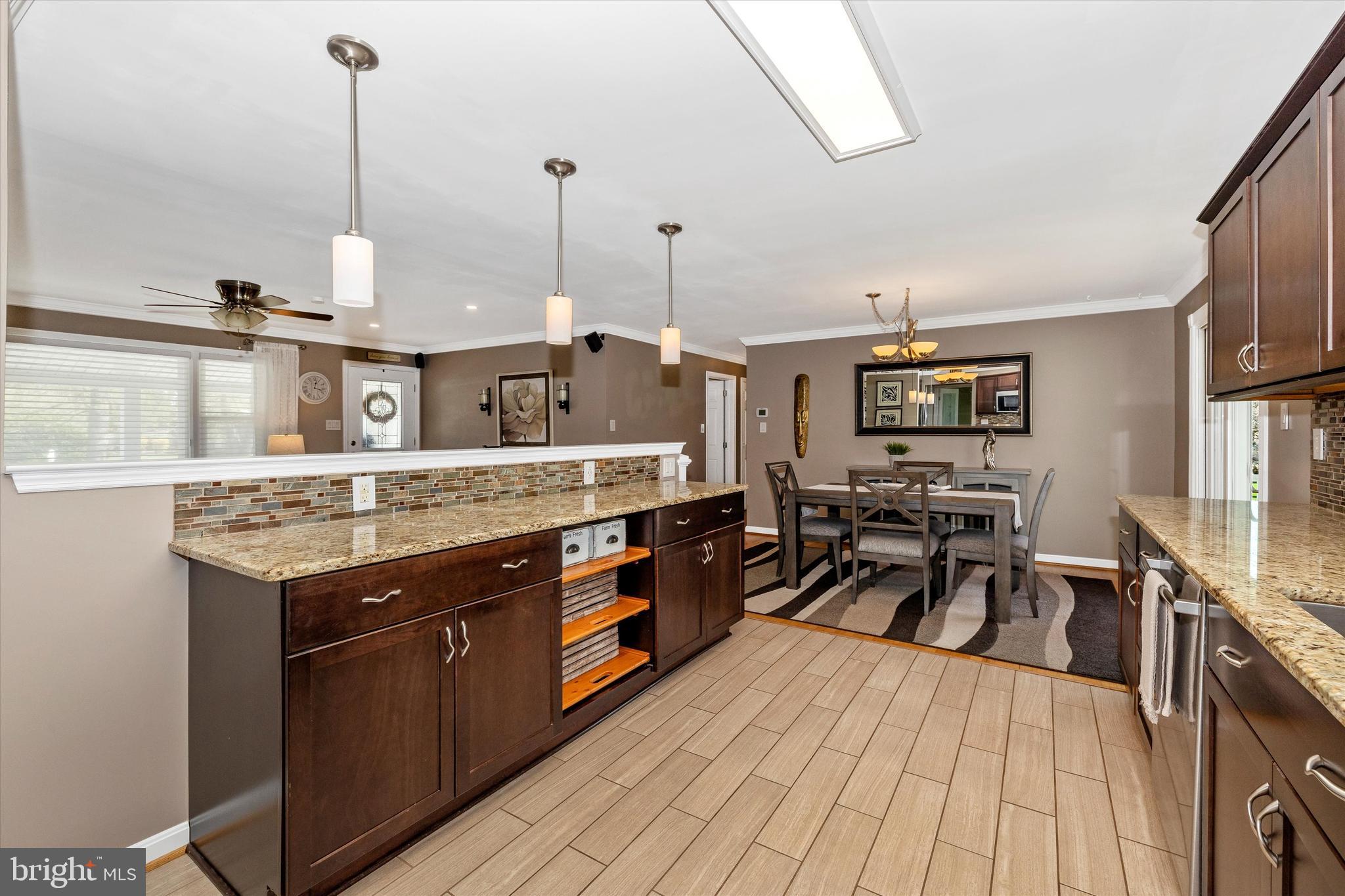 8107 Broadview Drive Frederick, MD 21701 - Photo 18 of 54 a kitchen with stainless steel appliances granite countertop a stove a sink dishwasher and a wooden cabinets