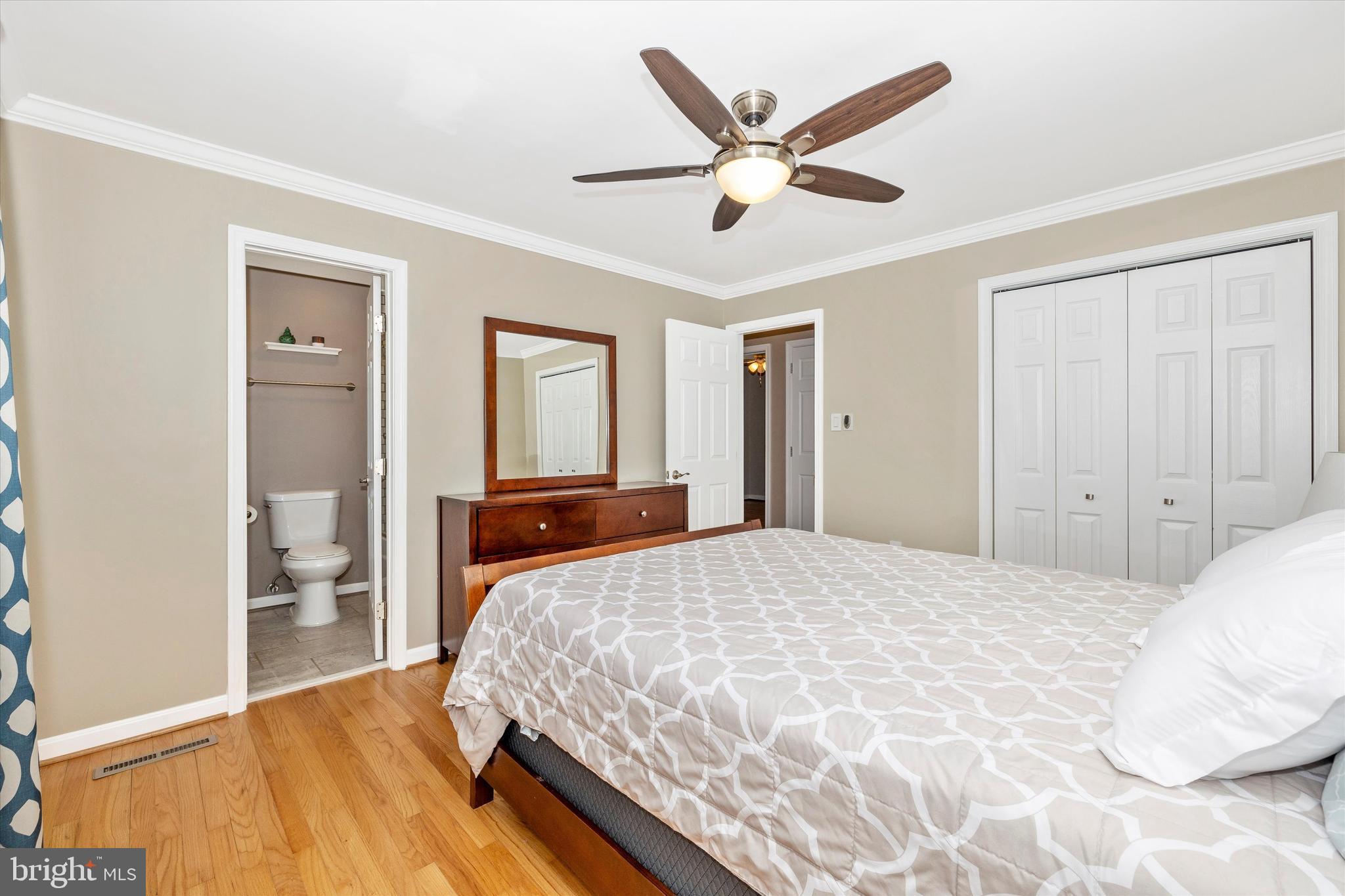8107 Broadview Drive Frederick, MD 21701 - Photo 21 of 54 a bedroom with a large bed and a chandelier
